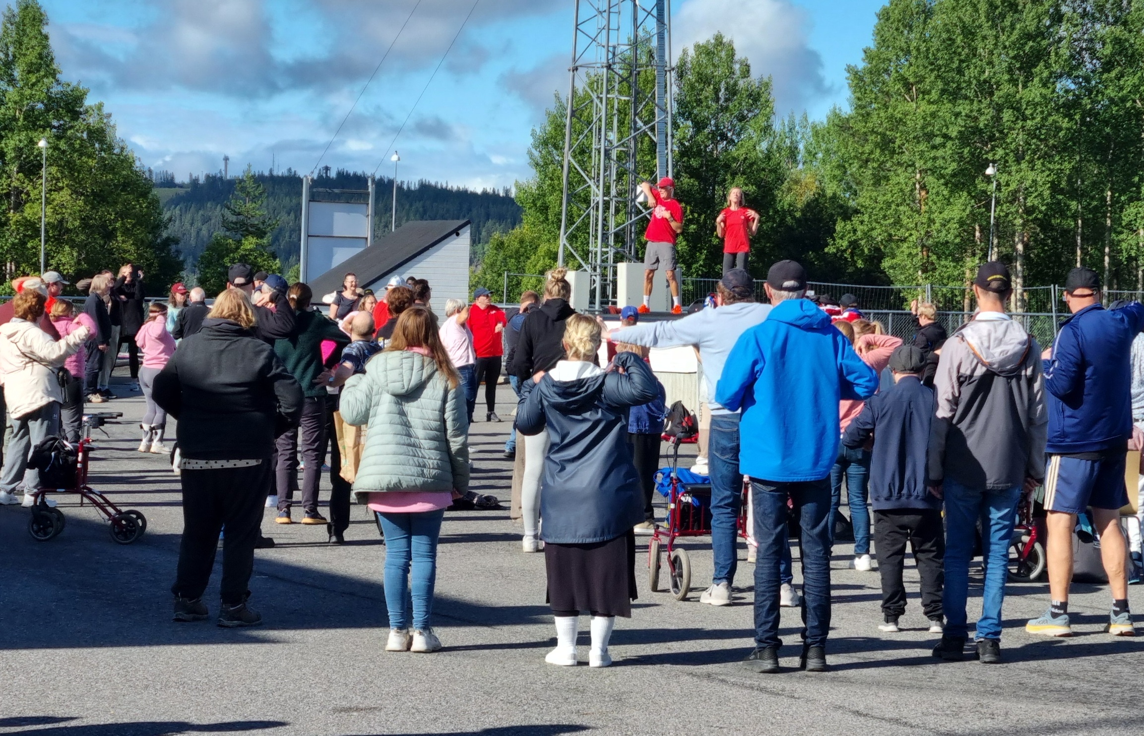 DV-dagen_I förgrunden ryggar på mycket folk som tittar på 2 rödklädda personer ifrån Friski&Svettis, som håller i uppvärmningen.