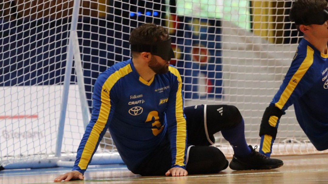 En svensk spelare sitt på mållinjen.
