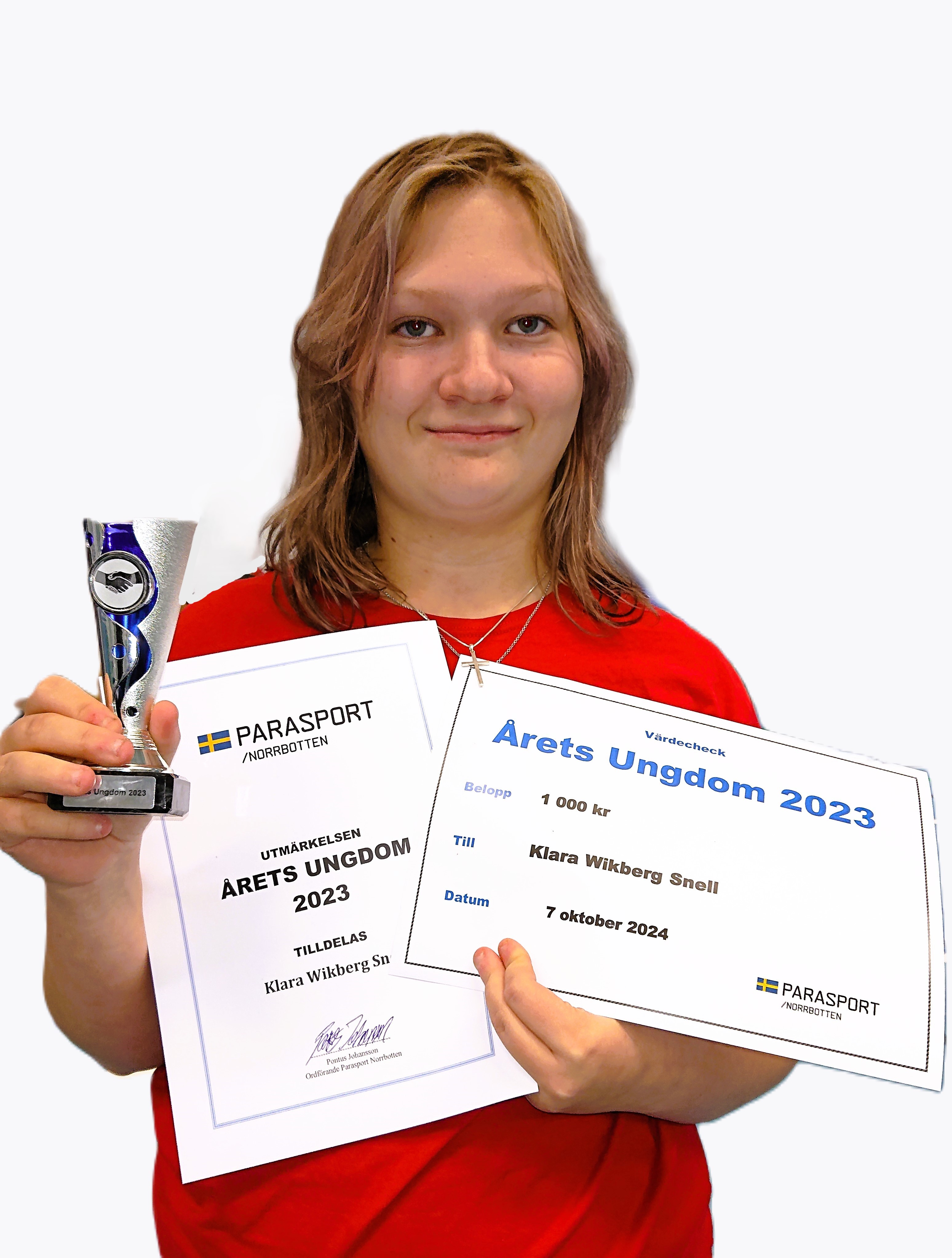 Klara Wikberg håller glatt upp sin pokal och sitt diplom