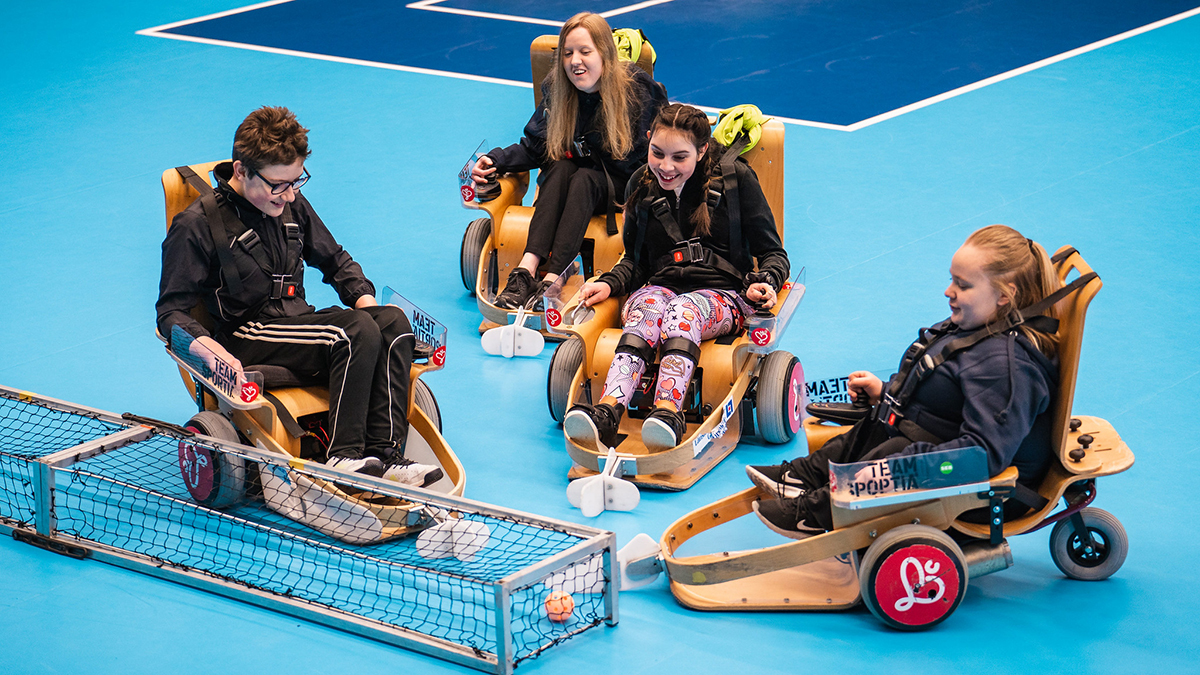 Fyra personer spelar elinnebandy på en prova på-dag.